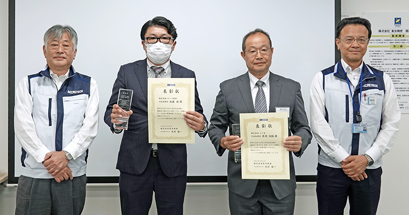 Supplier representatives shown with certificates of recognition